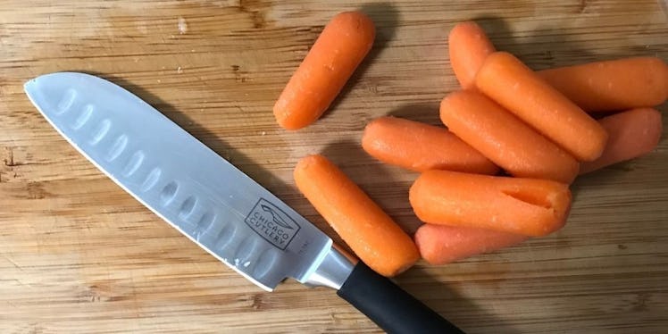 Carrots and knife on a wooden cutting board