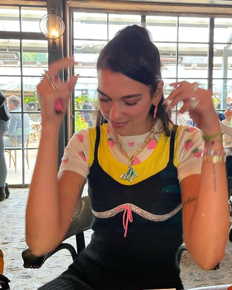 Dua Lipa wearing Mayol's Jenna Necklace with a graphic tee and a black slip dress.