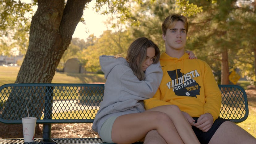 Grayson Leavy and Zoey Watson cuddling on a park bench on 'Titletown High'.