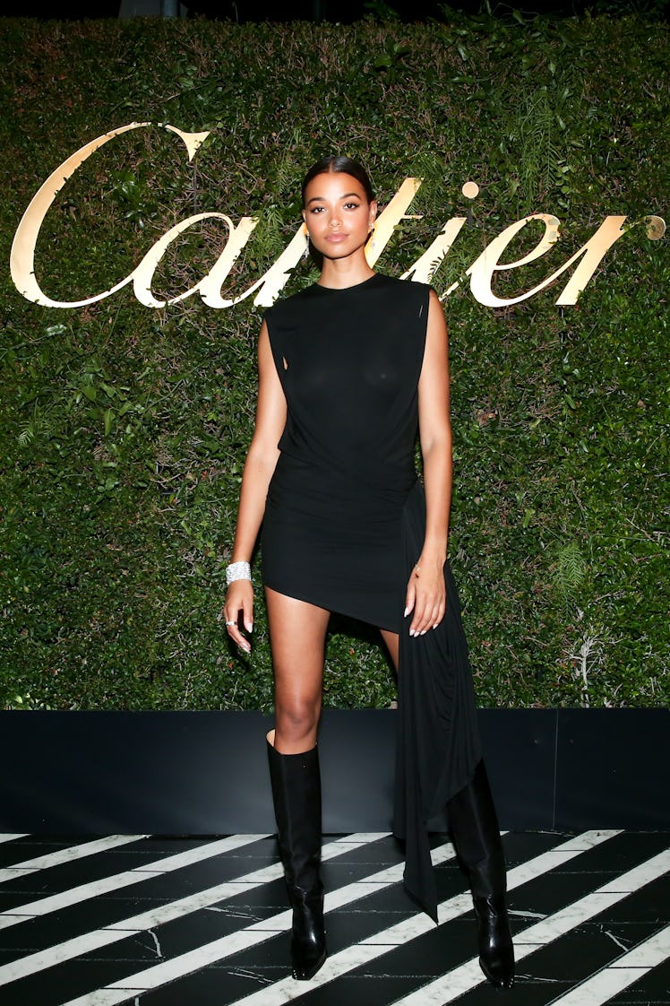 Ella Balinska posing in a black mini dress at the Cartier party