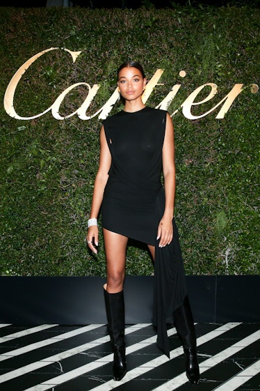 Ella Balinska posing in a black mini dress at the Cartier party