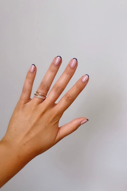 A navy blue French manicure is one of fall 2021's biggest nail trends as a twist on the classic Fren...