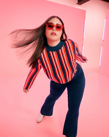 A model in a striped shirt, wide pants and red sunglasses from the Target Fall Designer Collection