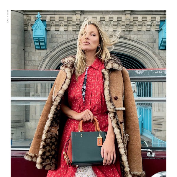 Kate Moss stars in Coach's new Rogue bag campaign, carrying a Rogue 25 handbag in green and orange c...