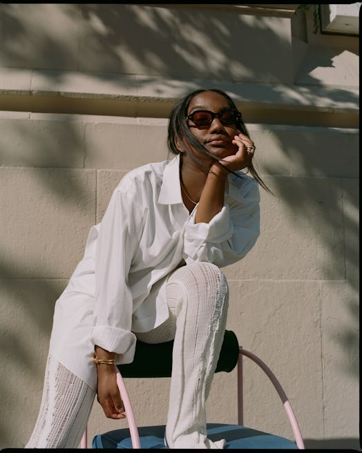 Telsha Anderson posing in a white shirt and pants combination
