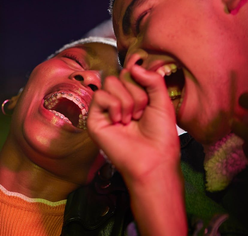 A young couple laughing and celebrating how September 2021 will be the best month for their zodiac s...