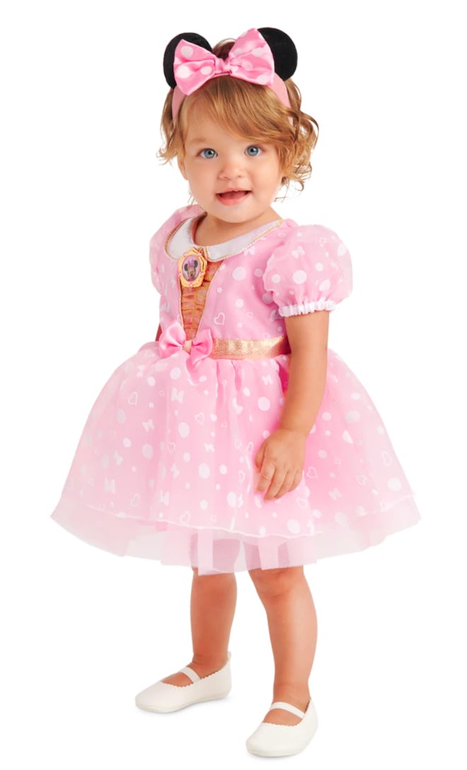 Little girl wearing pink dress and Minnie Mouse ears