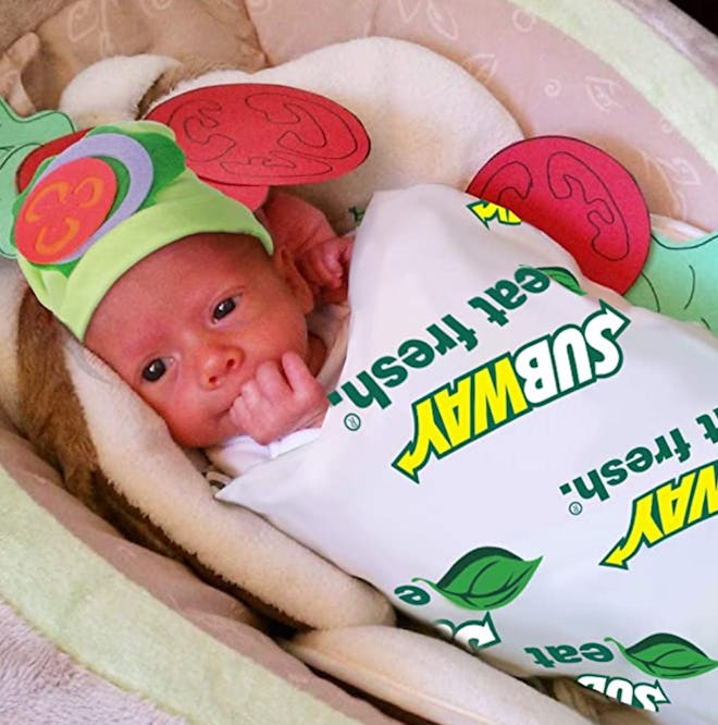 Infant swaddled in blanket to look like a subway foot-long sandwich 
