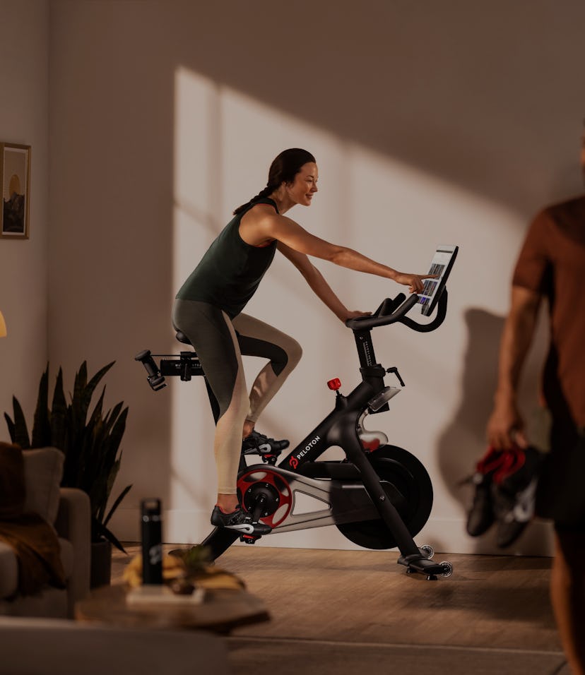 A woman riding a Peloton bike