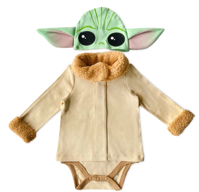 Flat lay of baby onesie and hat that looks like Baby Yoda