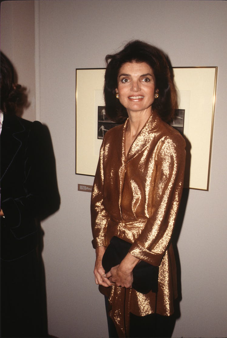 Jackie Kennedy in a shimmering bronze blouse at the International Center of Photography in New York ...