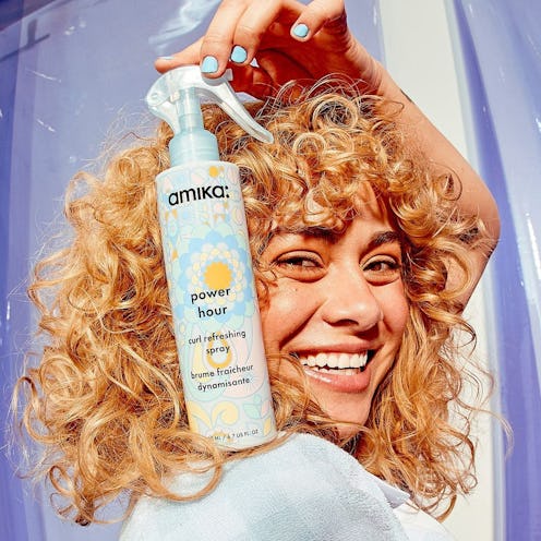 Amika model holding new curl-enhancing spray