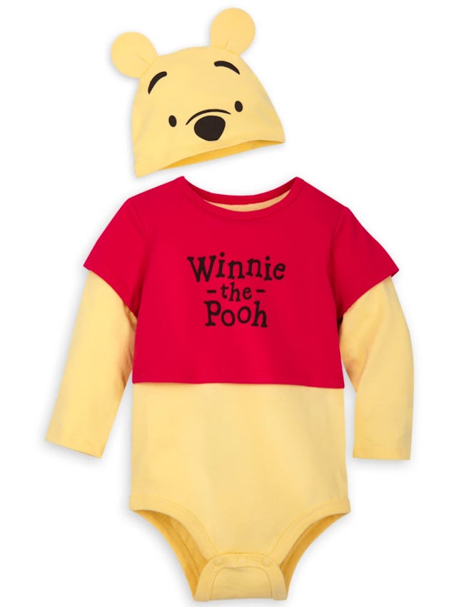 Flay lay of baby onesie and hat that look like Winnie the Pooh