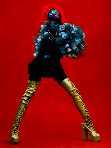 Adhel Bol wears a Giorgio Armani cape and skirt; Natacha Marro boots.
