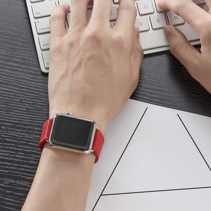 apple watch with bright red band on person typing on keyboard