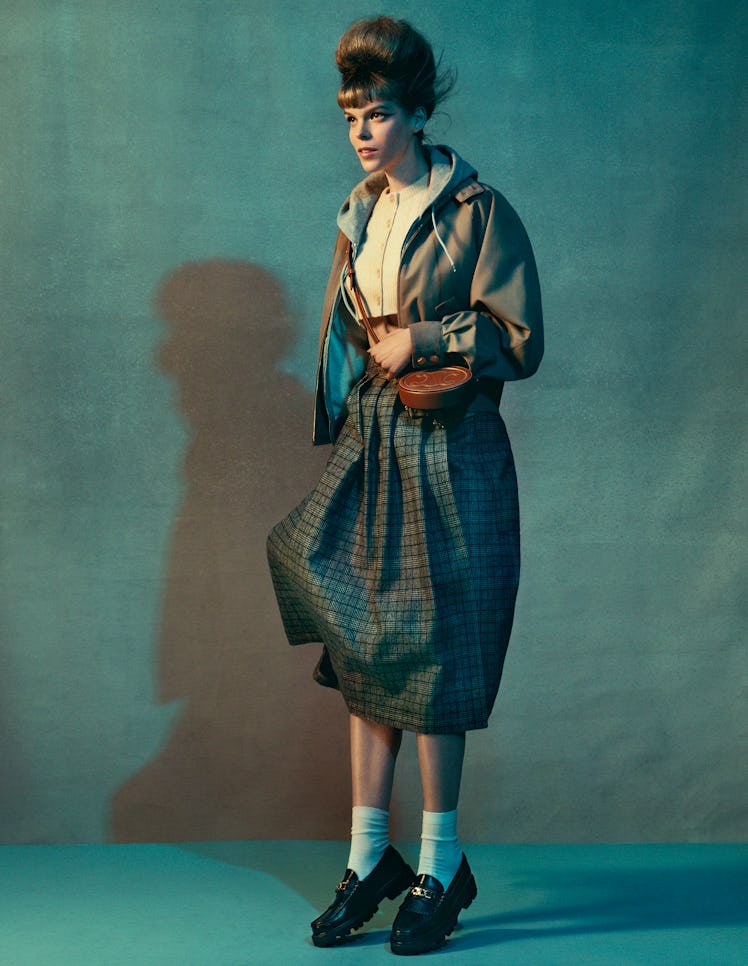 Model Meghan Collison wears a Celine by Hedi Slimane jacket, hoodie, cropped cardigan, skirt, bag, a...