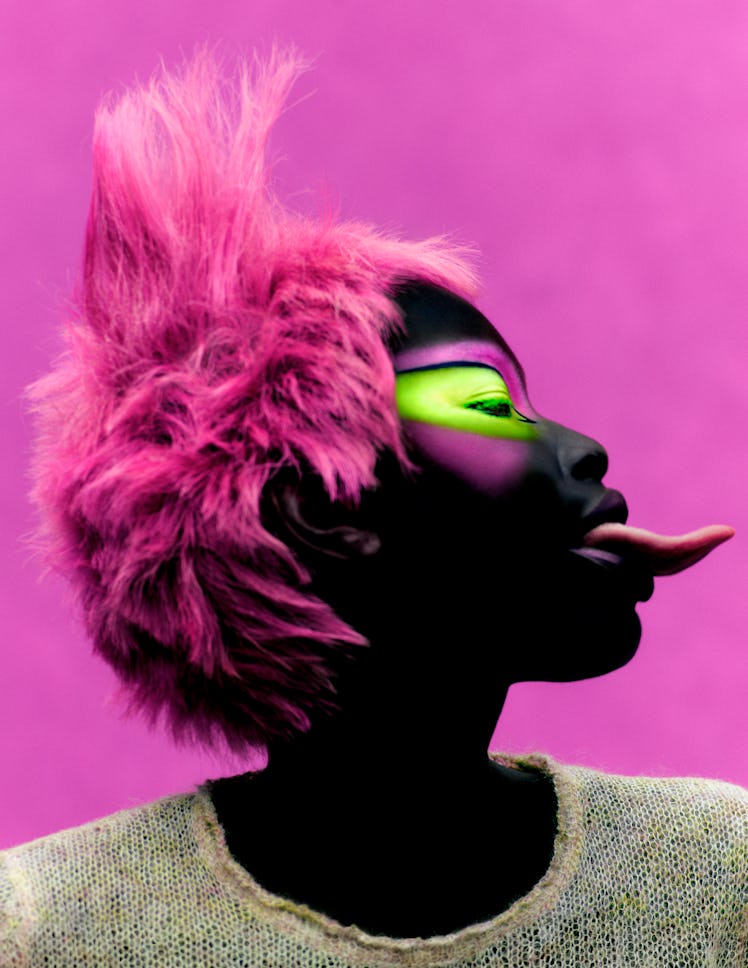 Adhel Bol with pink hair wearing a Miu Miu sweater in beige