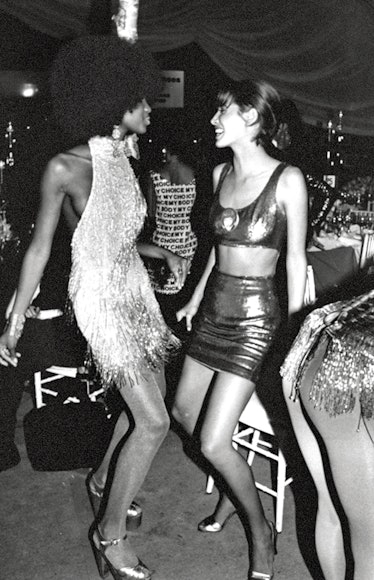 Christy Turlington dancing with Naomi Campbell at Seventh on Sale in 1990. 