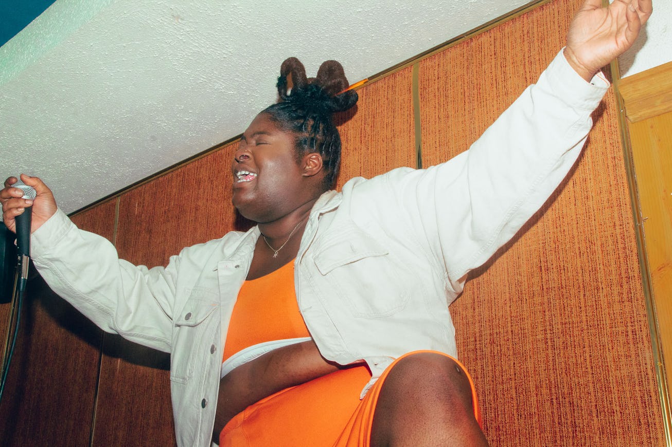 Rapper Chika in Calvin Klein's orange top and shorts with a beige jacket performing at The Flower Sh...