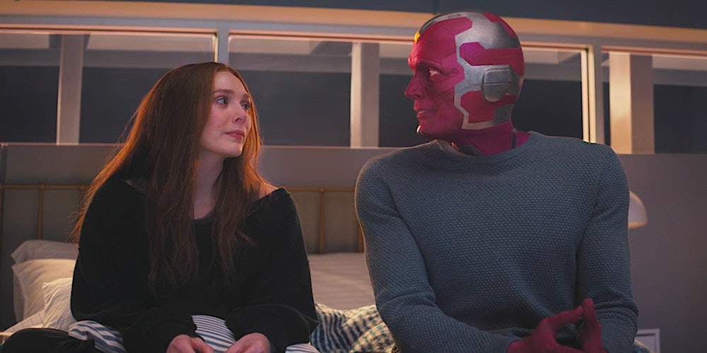 Wanda and Vision sit next to each other during a flashback in WandaVision