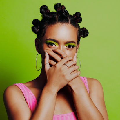 Young woman covering her mouth during the August 2021 new moon in Leo, which will affect her zodiac ...