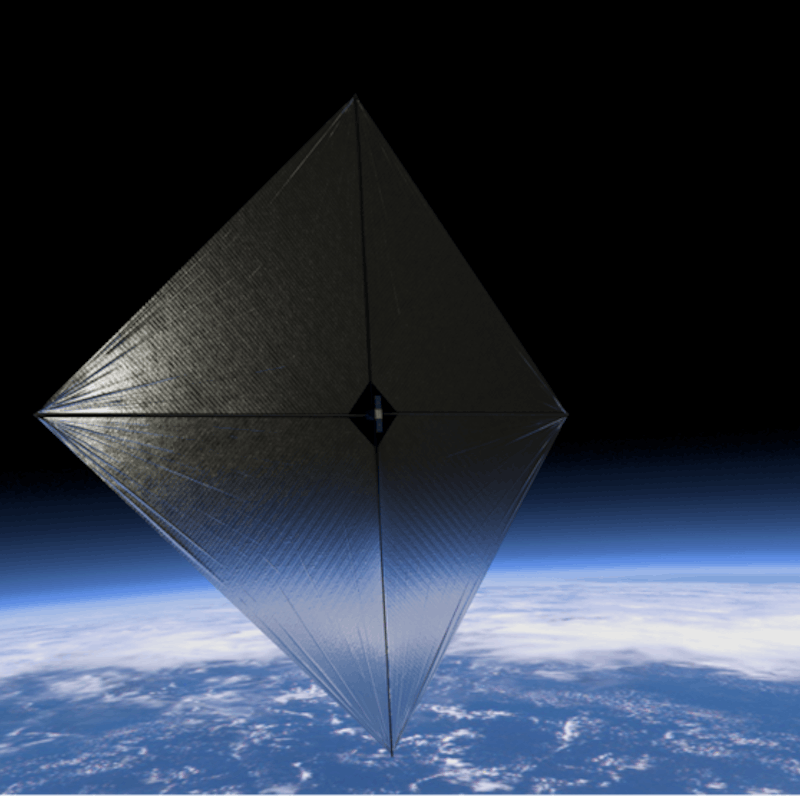 A metallic sun sail floating above Earth