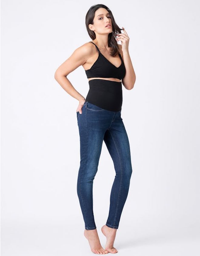 Woman in black bra modeling high-waist postpartum jeans