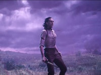 Loki standing on a hill with gloomy clouds above and wind blowing his hair to the back  