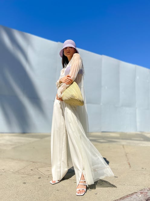 Julia Comil wears a White Tulle shirt dress, high waisted oversized white pants, a mauve pale purple...