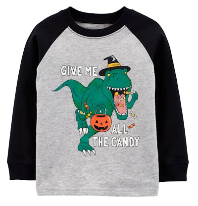 Image of a shirt with a green dinosaur on it, holding a trick-or-treating pumpkin candy bucket.