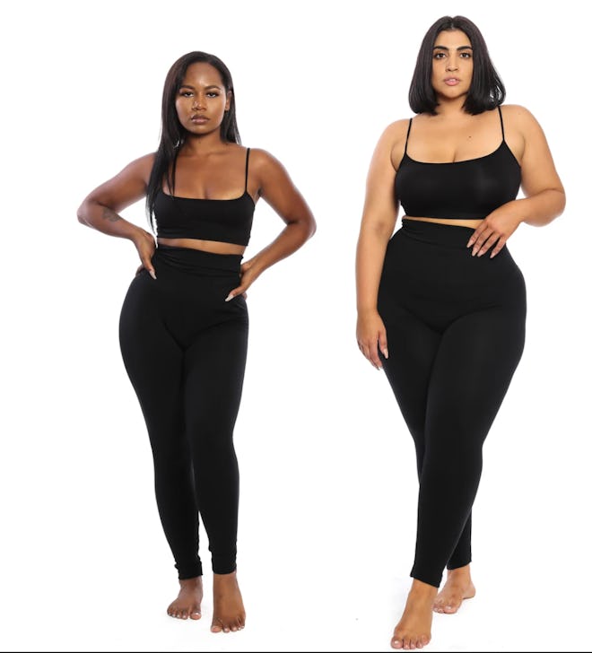 Two women standing in matching black bras and high-waist leggings