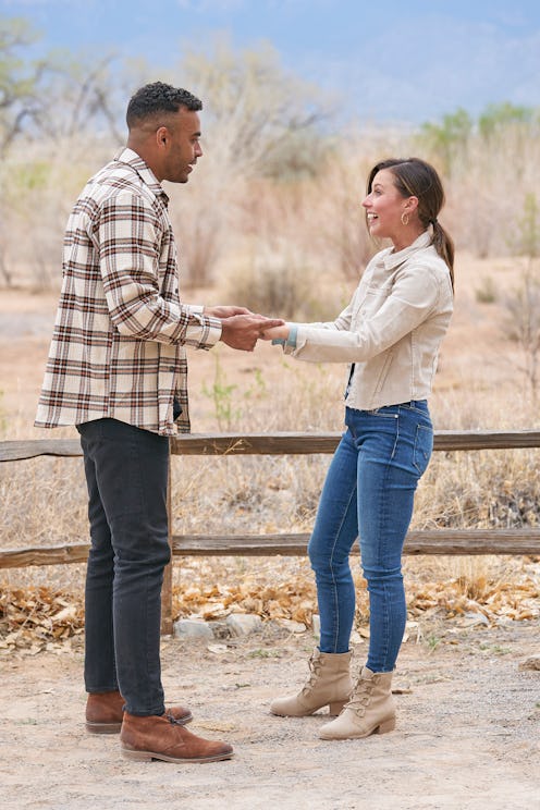 Katie Thurston and Justin Glaze grasping hands during their hometown date.