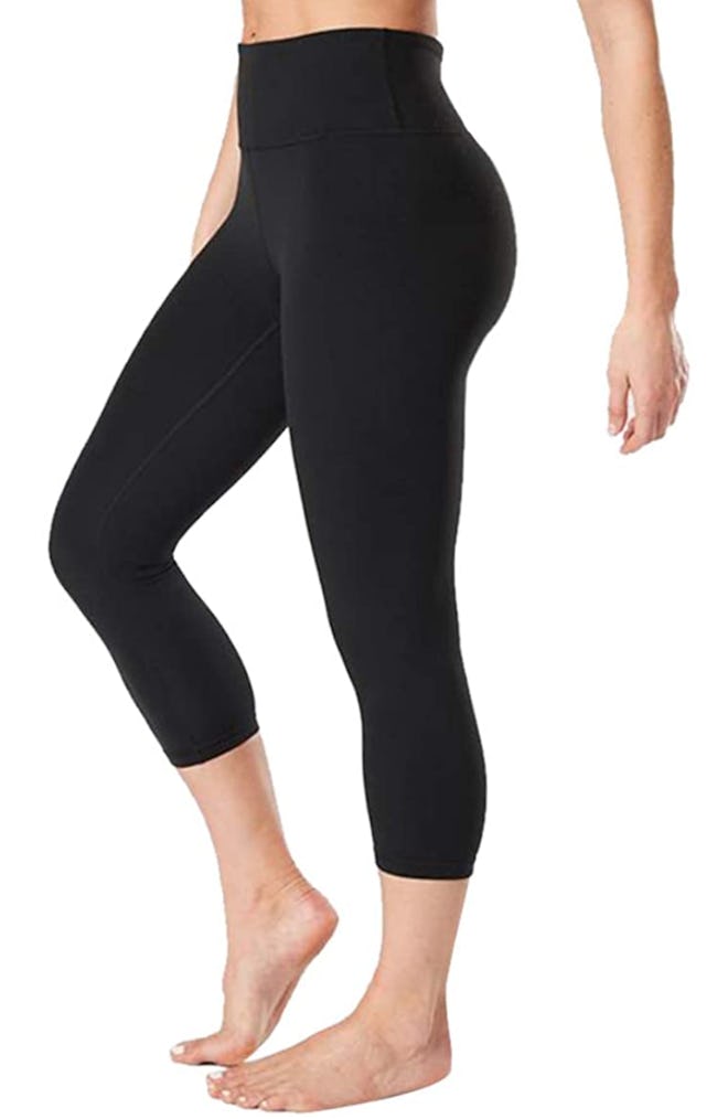 Waist-down photo of model wearing black high-waisted crop leggings