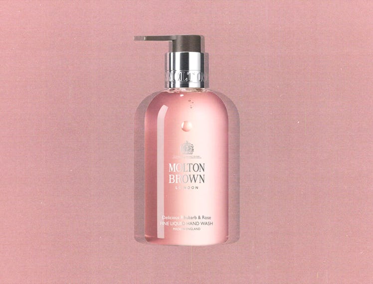 a bottle of Molton Brown's rhubarb and rose hand soap against a pink background