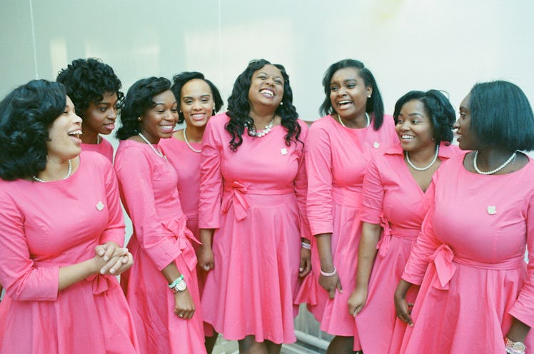 Photograph by Mayan Toledano of a group of women all dressed in the same pink dresses