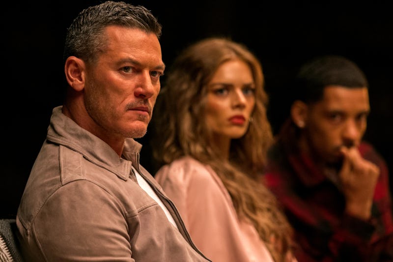 Lars (Luke Evans), Jessica (Samara Weaving), and Ben (Melvin Gregg) listen to Masha in 'Nine Perfect...