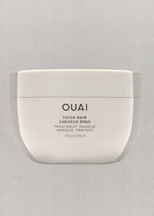 a tub of Ouai hair mask against a grey background