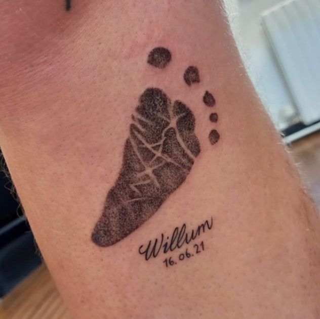 Baby footprint tattoo with child's name on the forearm