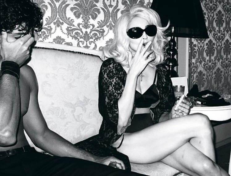Madonna smoking in a robe.