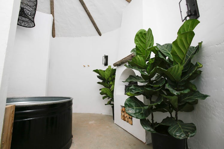 The inside of the bathroom at the potato-inspired hotel on Airbnb has a tub and fireplace. 