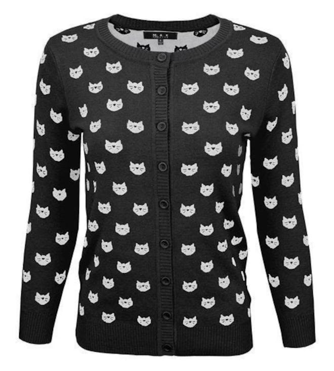 A black and white cardigan with cats on it completes an Angela Martin Halloween costume.