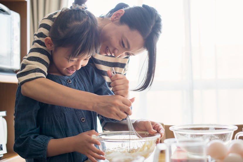 Mother and daughter making cookies together