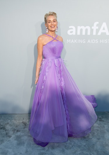 Sharon Stone wearing sleeveless purple gown with purple feathers