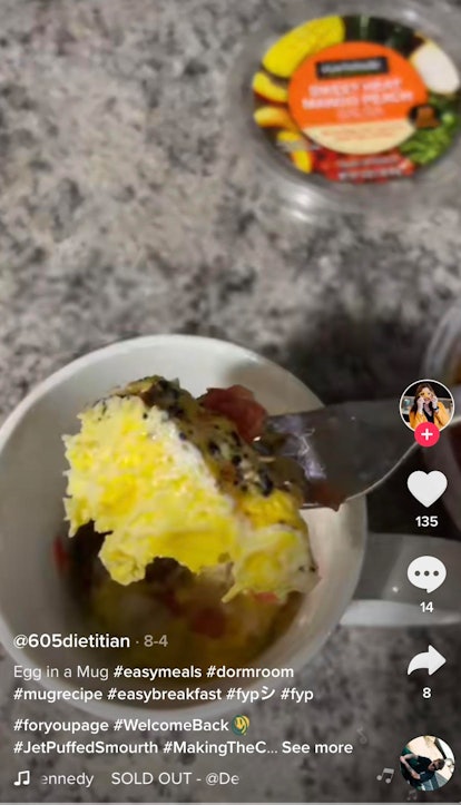 A woman makes eggs in a mug for an easy dorm room-friendly recipe on TikTok. 