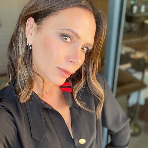 Victoria Beckham wears black military detail pleated dress from her brand, Victoria Beckham, on Inst...
