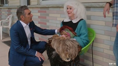 Moira holding her wigs after a small fire at the motel in Season 6, Episode 1 of 'Schitt's Creek'
