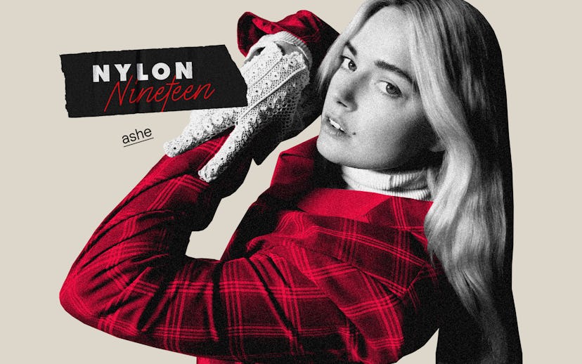 Ashe in a checkered red blazer, white turtleneck and white embroidered gloves