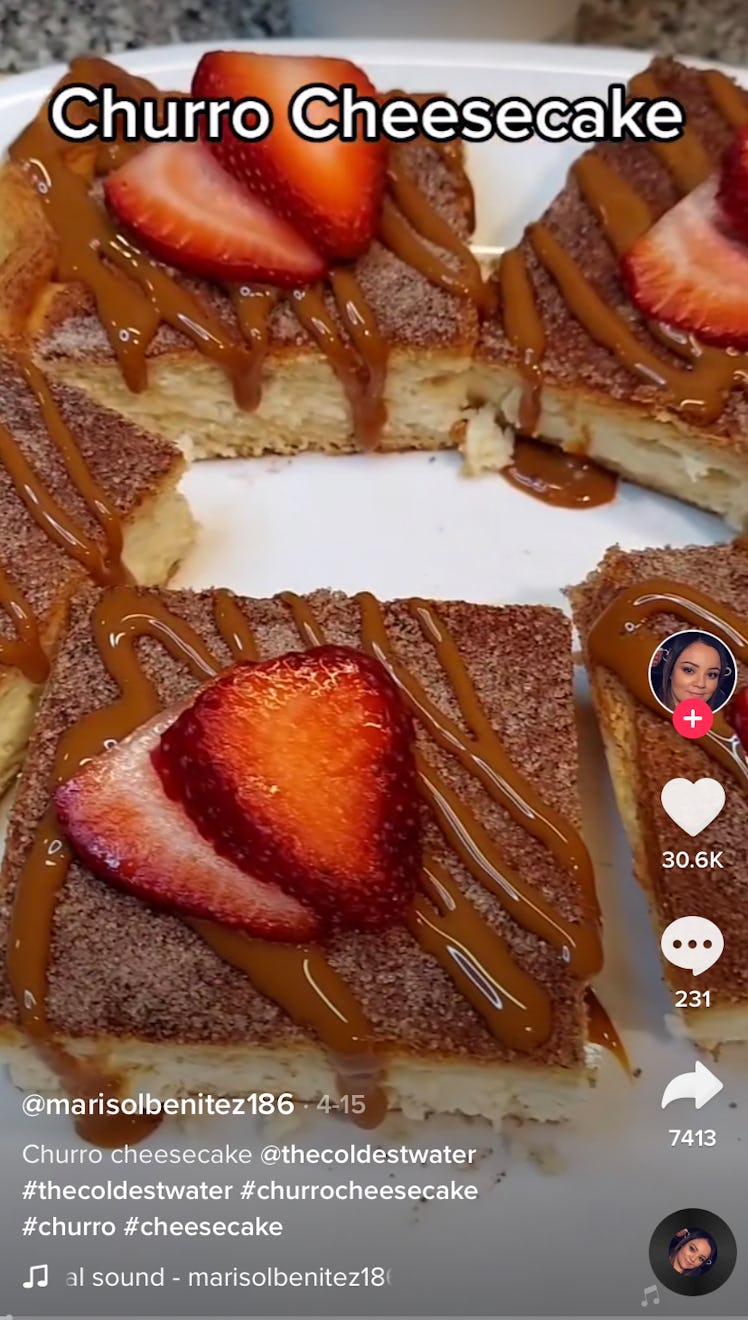 A plate of churro cheesecake bars from TikTok sits on a plate with strawberries on top. 