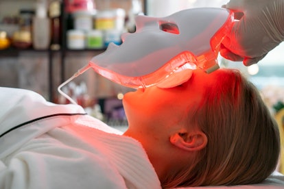 Woman getting LED light treatment from a doctor