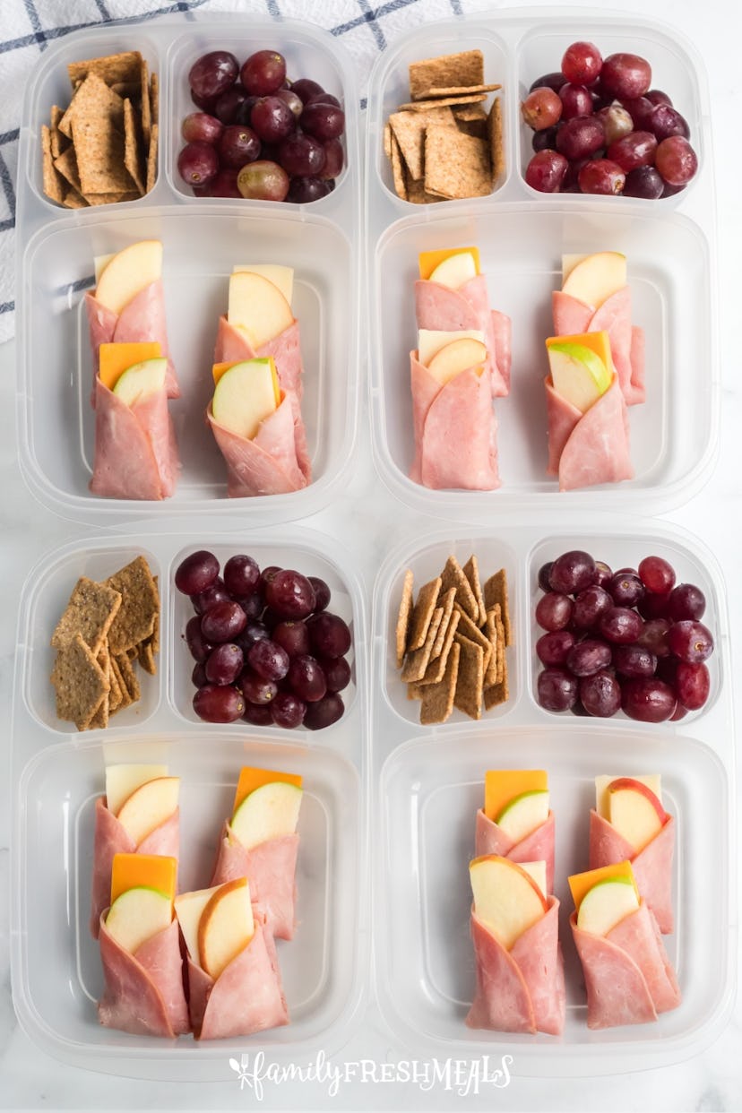 toddler lunch box with ham, cheese, and apple wraps and snacks